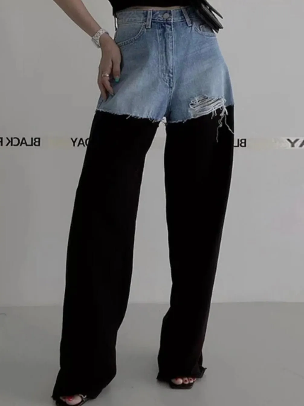 Blue jeans detail and black pants